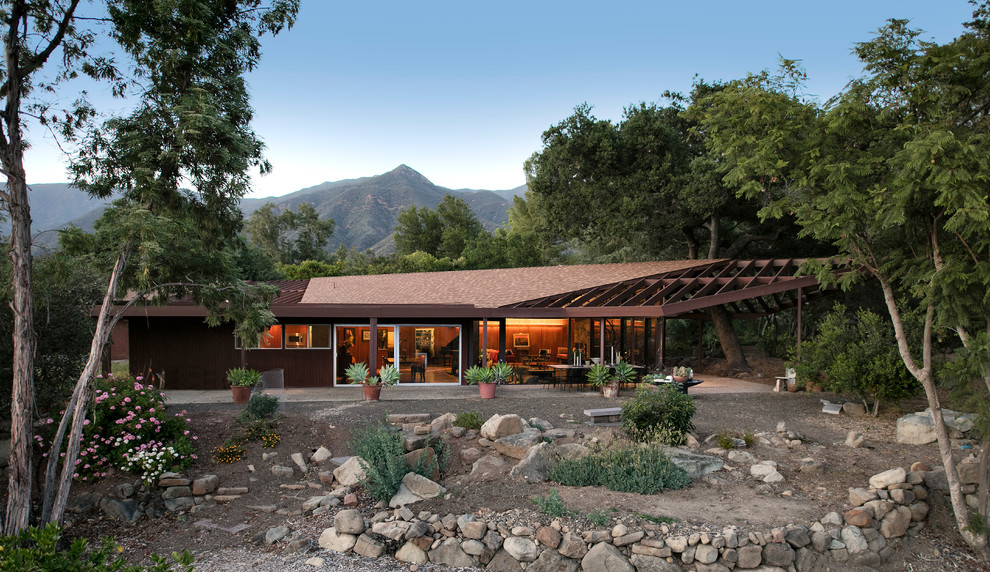 Inspiration for a mid-sized 1950s brown one-story wood gable roof remodel in Los Angeles