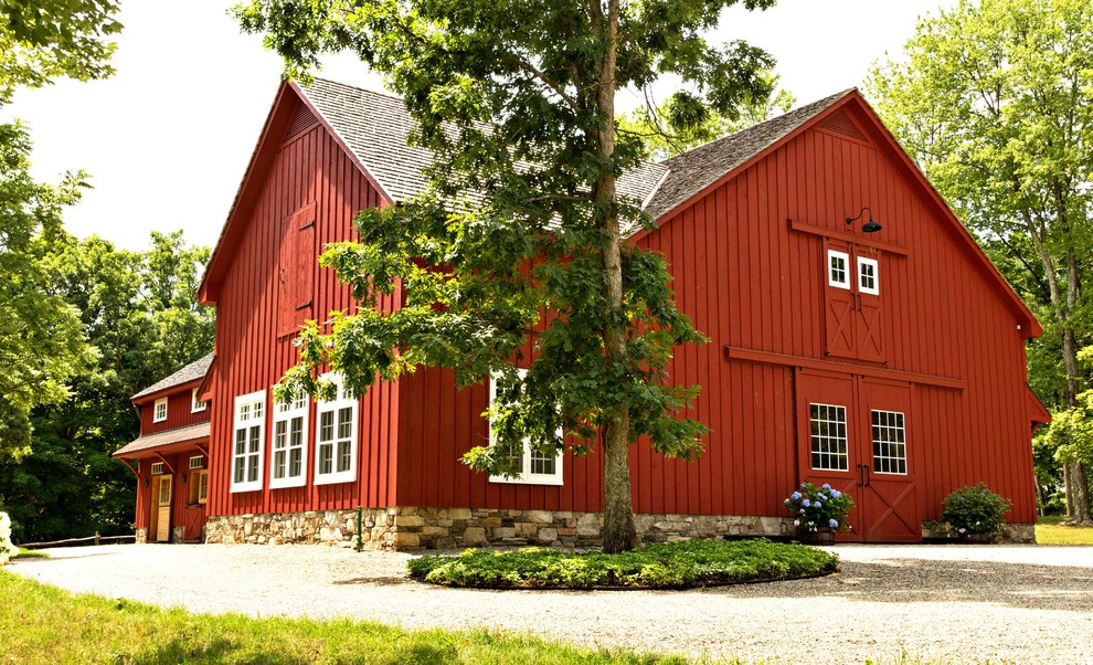 Photo of a medium sized and red farmhouse two floor house exterior in New York with wood cladding.
