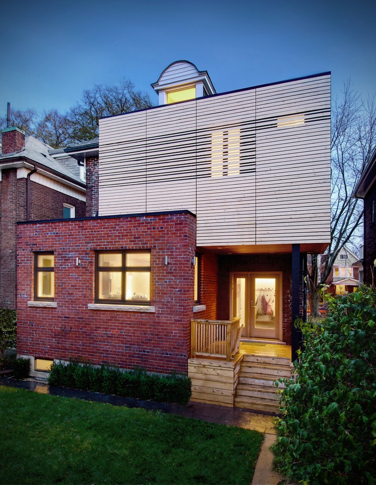 Modelo de fachada de casa multicolor actual de tamaño medio de dos plantas con revestimientos combinados