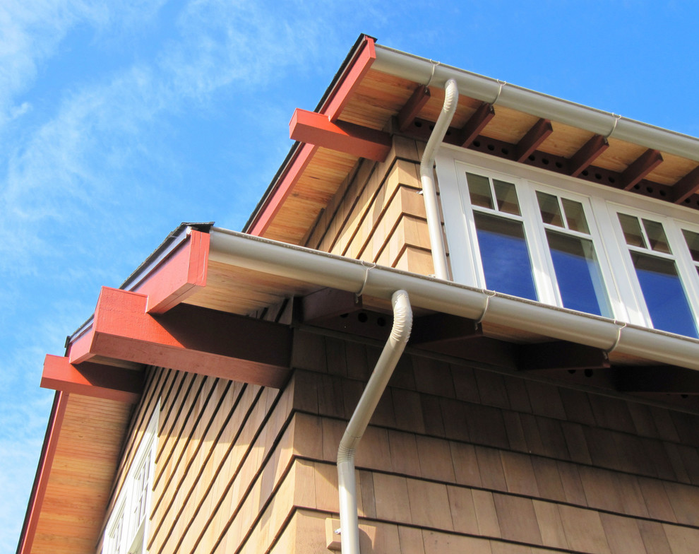 Example of a mid-sized arts and crafts beige two-story wood gable roof design in Seattle