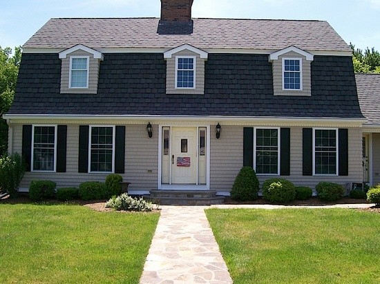 Example of a mid-sized classic brown two-story wood house exterior design in Bridgeport with a gambrel roof and a shingle roof