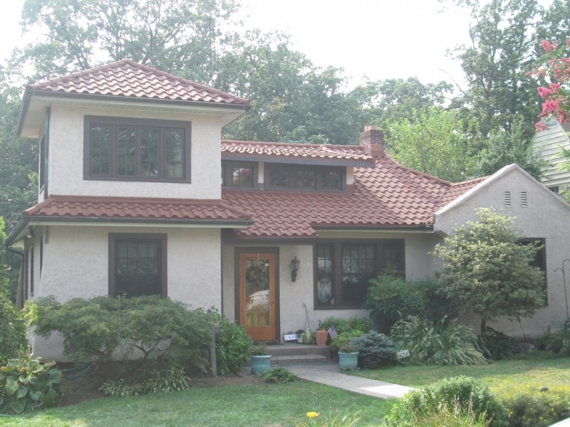 Inspiration for a medium sized and white mediterranean two floor render house exterior in DC Metro with a hip roof.