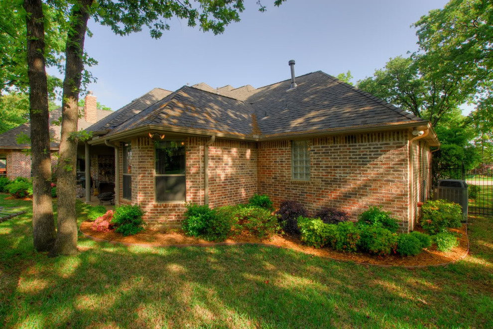 Example of a mid-sized mountain style red one-story brick gable roof design in Dallas