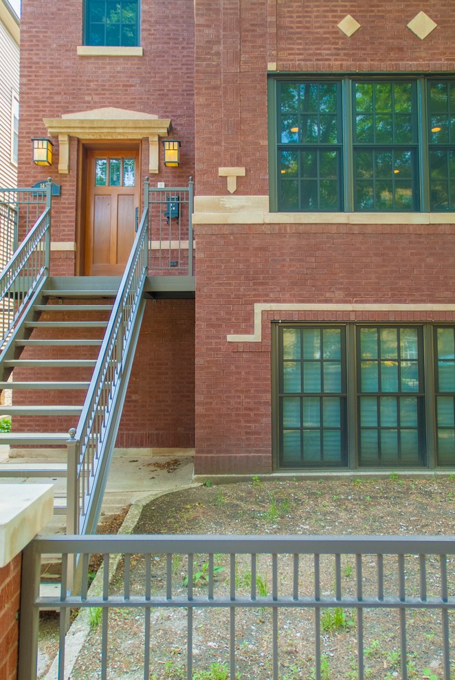 Large and red industrial brick house exterior in Chicago with three floors.