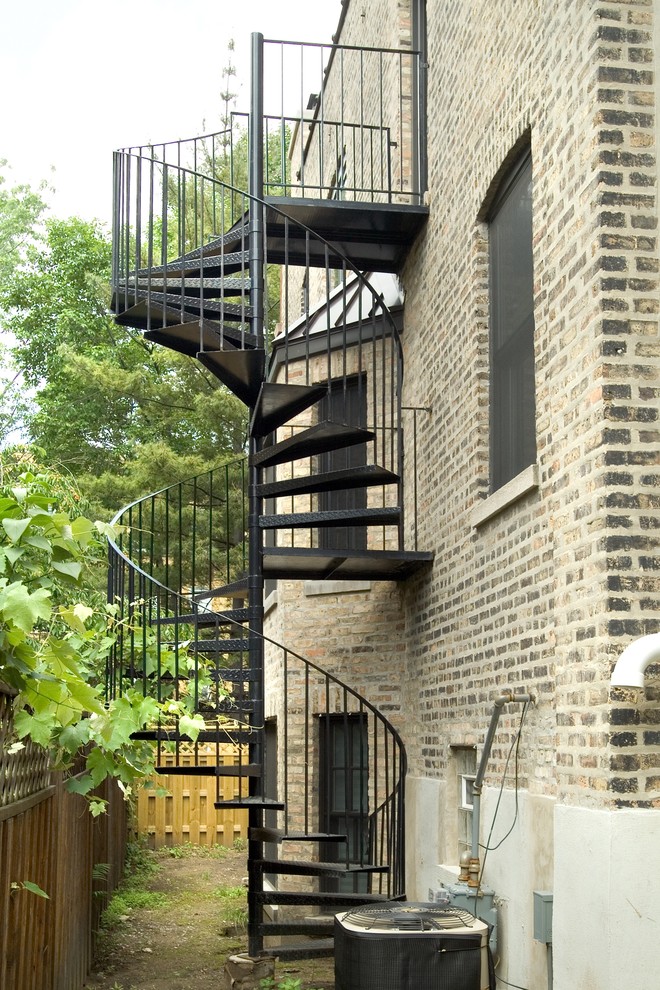Inspiration for a large and red urban brick house exterior in Chicago with three floors.