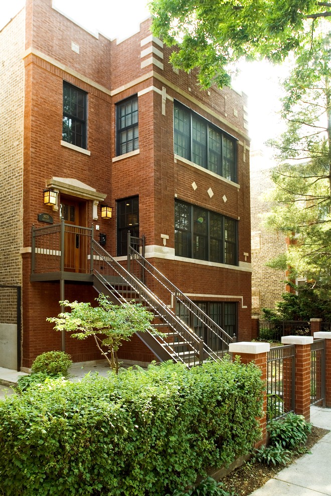 Example of a large urban red three-story brick exterior home design in Chicago