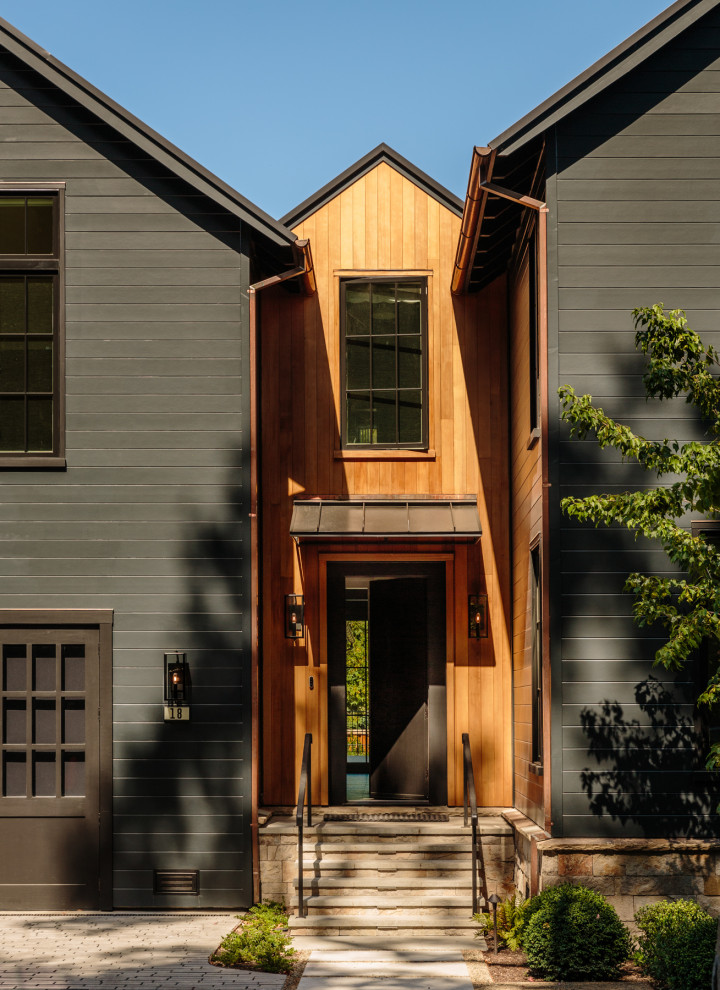 Inspiration for a large country black two-story mixed siding exterior home remodel in San Francisco with a metal roof