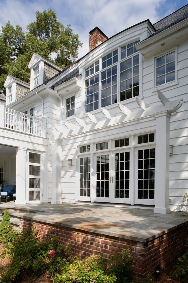 Large elegant white three-story wood exterior home photo in Baltimore with a tile roof