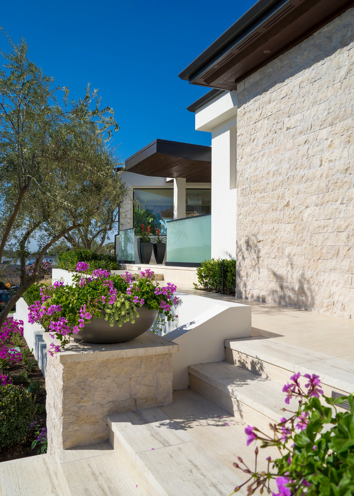 Inspiration for a large contemporary white two-story stucco flat roof remodel in Orange County