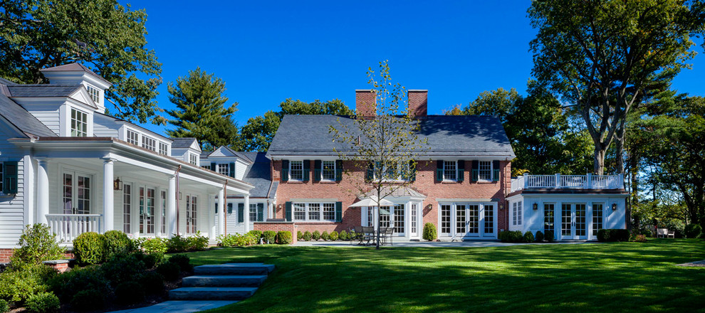 This is an example of a large classic two floor brick house exterior in Boston.