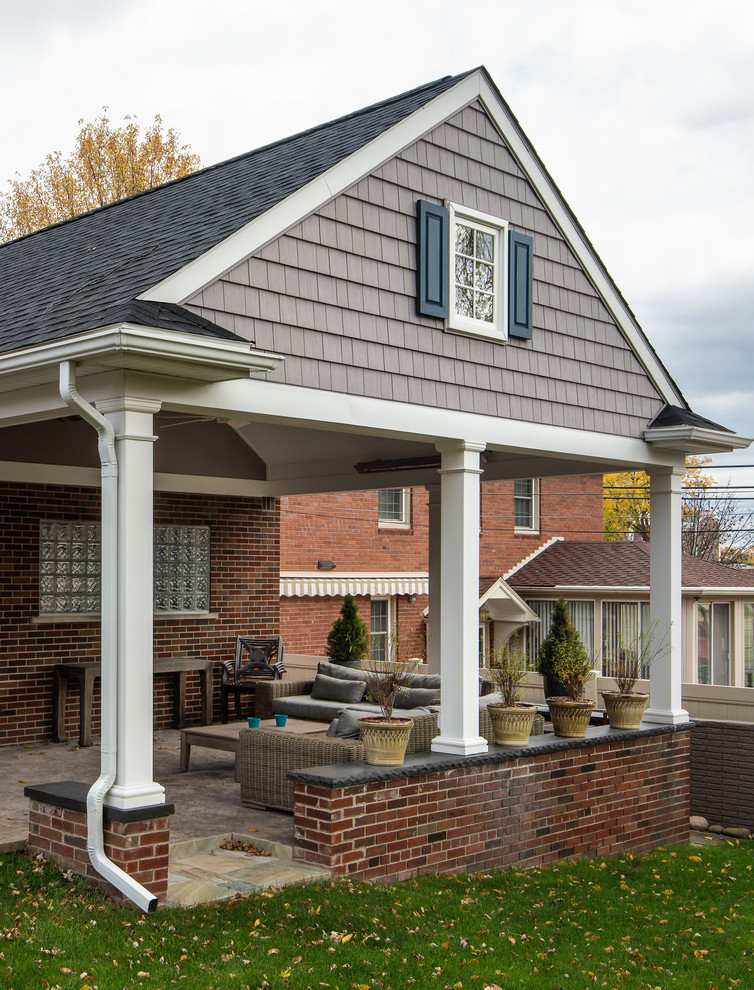 Small traditional gray one-story brick exterior home idea in Detroit with a shingle roof