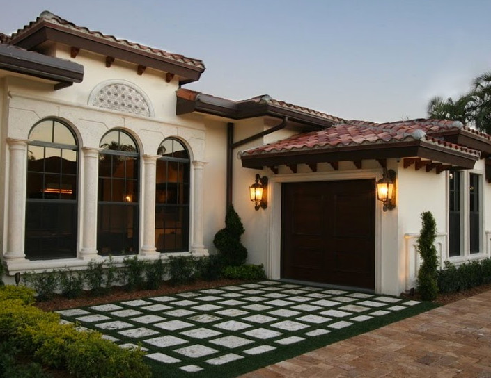 Example of a small tuscan white one-story stucco exterior home design in Miami