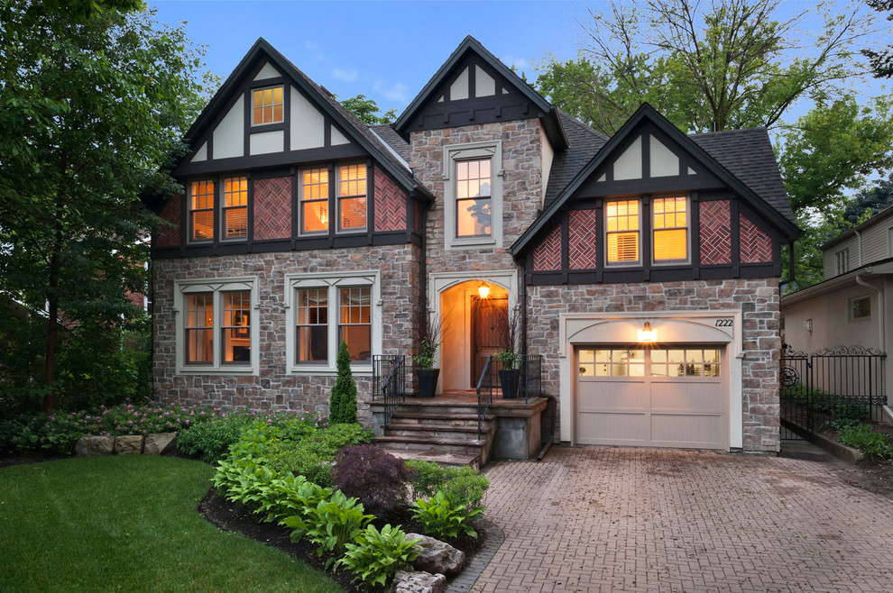 Inspiration for a classic two floor house exterior in Toronto with mixed cladding.