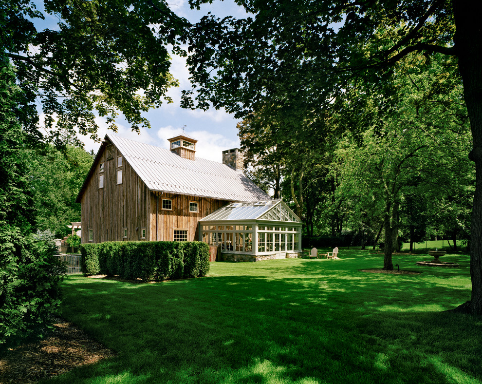 Große, Zweistöckige Country Holzfassade Haus mit brauner Fassadenfarbe und Satteldach in New York