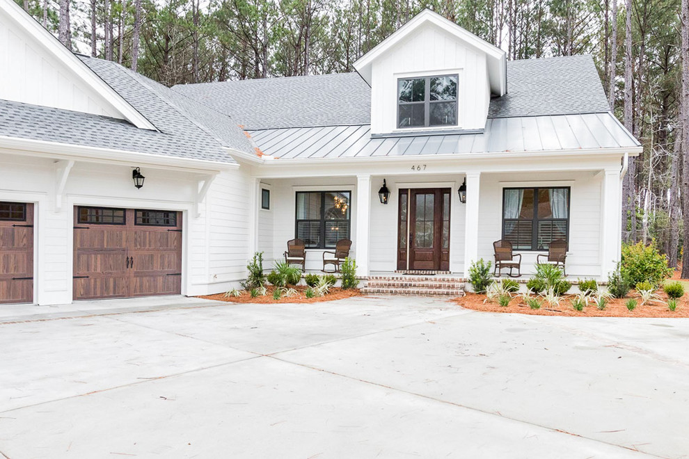 Example of a mid-sized country white two-story wood house exterior design in Atlanta with a metal roof