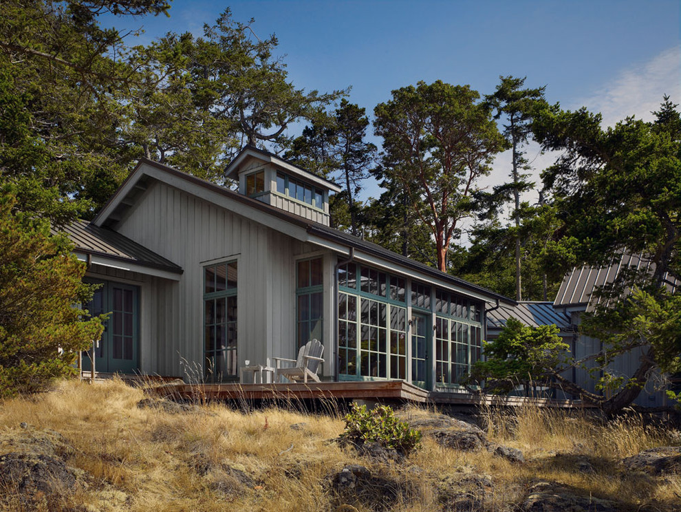 Design ideas for a rustic house exterior in Seattle with wood cladding.