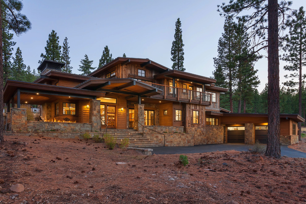 Inspiration for a rustic two floor house exterior in Sacramento with wood cladding and a pitched roof.