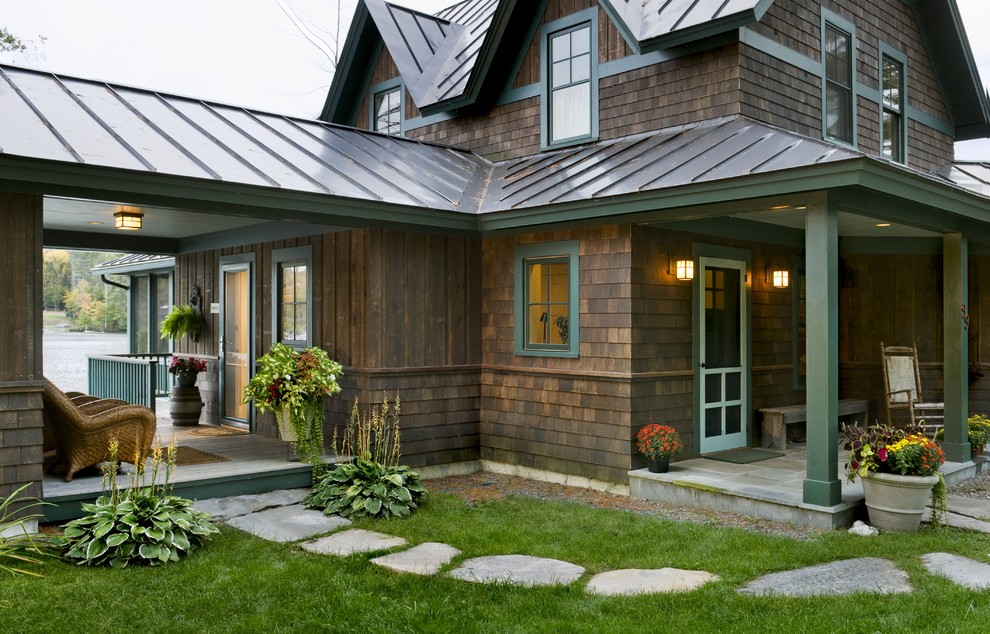Inspiration for a rustic two-story wood exterior home remodel in Burlington with a metal roof