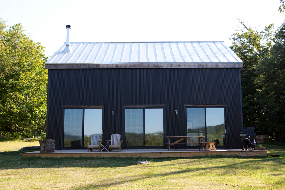 Photo of a medium sized and black rustic house exterior in Austin.