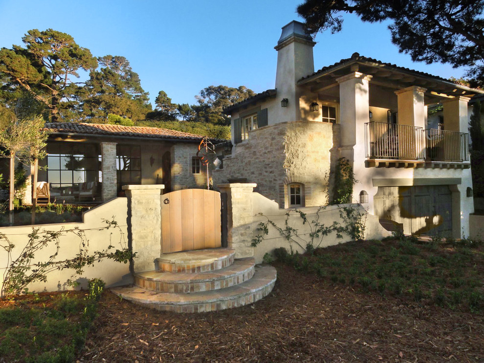 This is an example of a small and beige farmhouse two floor house exterior in Santa Barbara with stone cladding.