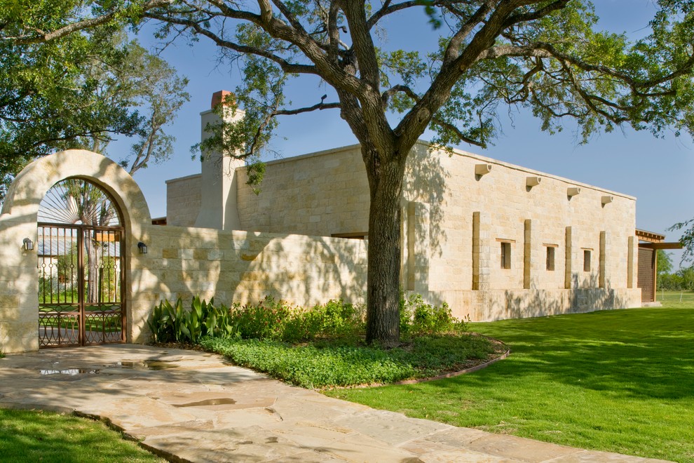 Imagen de fachada de estilo americano con revestimiento de piedra y tejado plano