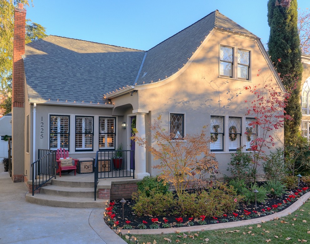 Traditional beige two-story exterior home idea in Sacramento with a clipped gable roof