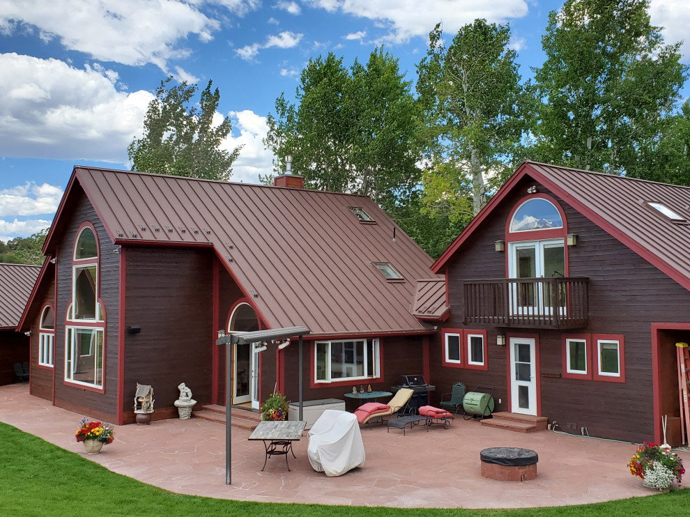 Rustic exterior home idea in Denver with a metal roof