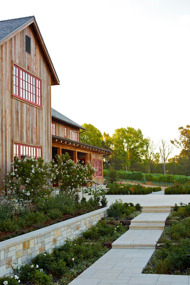 Inspiration for a rustic house exterior in Santa Barbara with wood cladding.