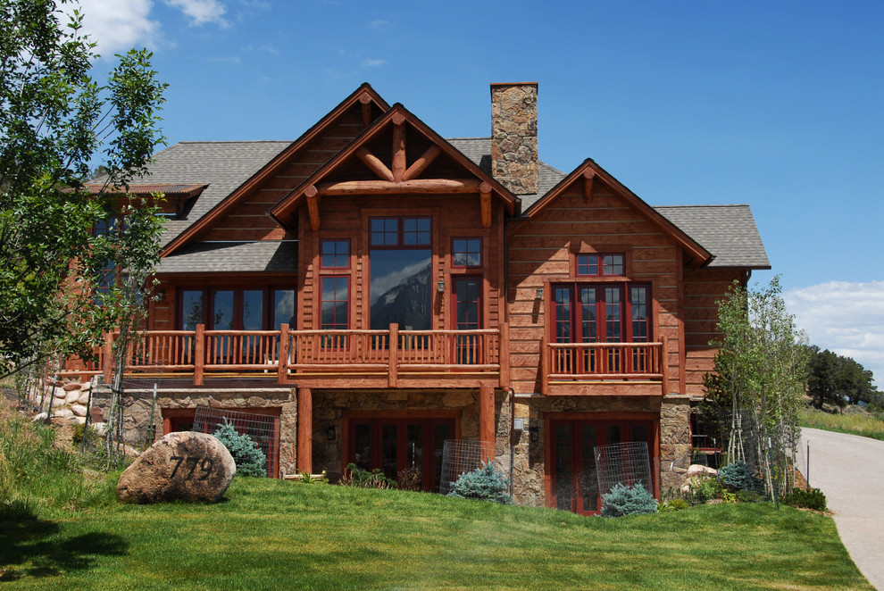 This is an example of a large and multi-coloured rustic two floor detached house in Denver with wood cladding, a shingle roof and a pitched roof.