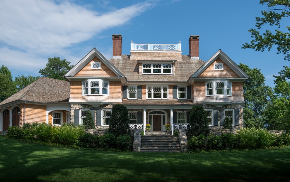 Example of a huge beach style gray three-story wood house exterior design in New York with a hip roof and a shingle roof