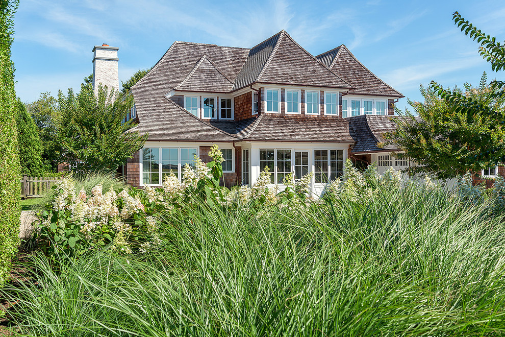 Inspiration for a large timeless gray two-story wood exterior home remodel in New York with a shingle roof