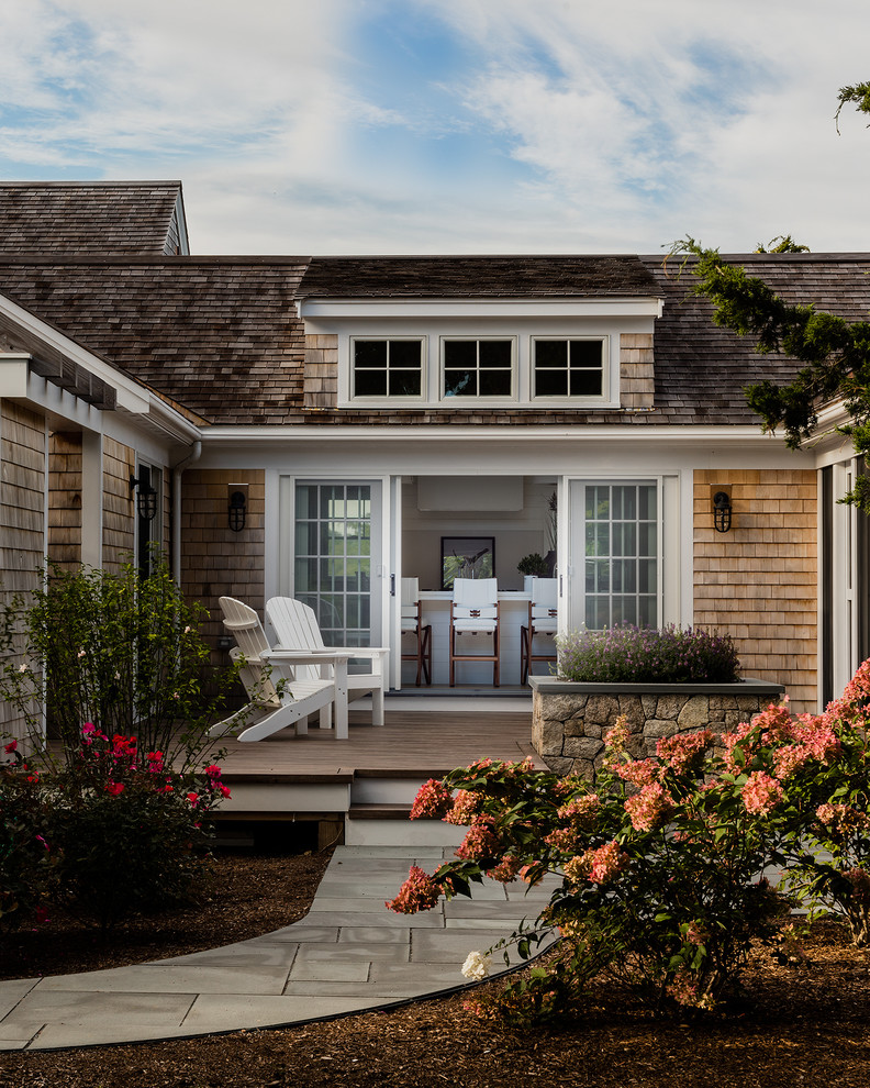 Example of a transitional two-story wood exterior home design in Boston with a shingle roof