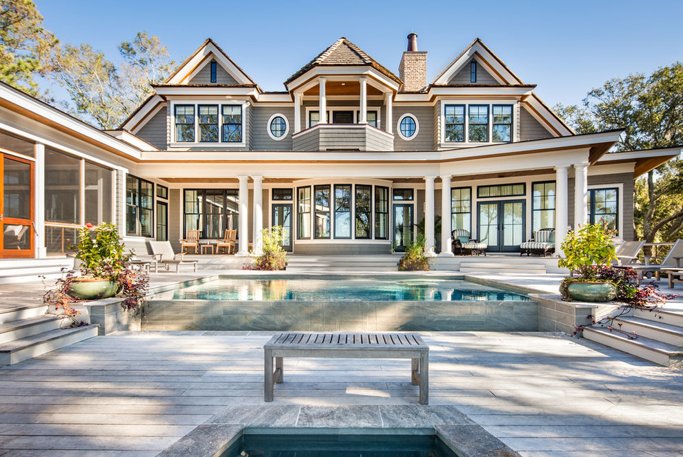 Large beach style gray two-story exterior home photo in Charleston with a shingle roof