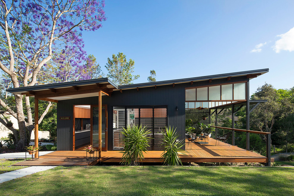 Kleines, Einstöckiges Modernes Einfamilienhaus mit Faserzement-Fassade, schwarzer Fassadenfarbe, Flachdach und Blechdach in Brisbane