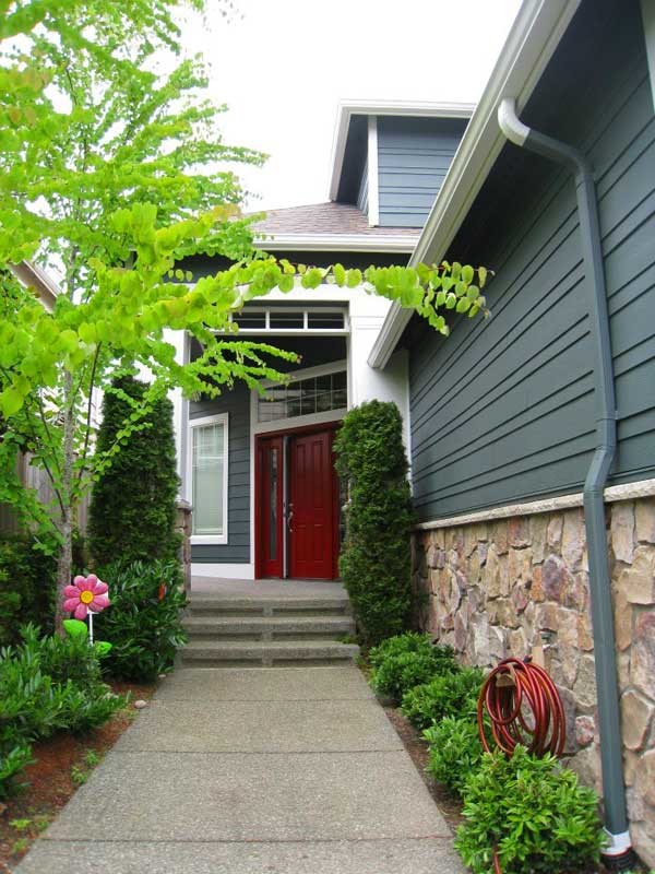 Mid-sized craftsman green three-story wood exterior home idea in Seattle