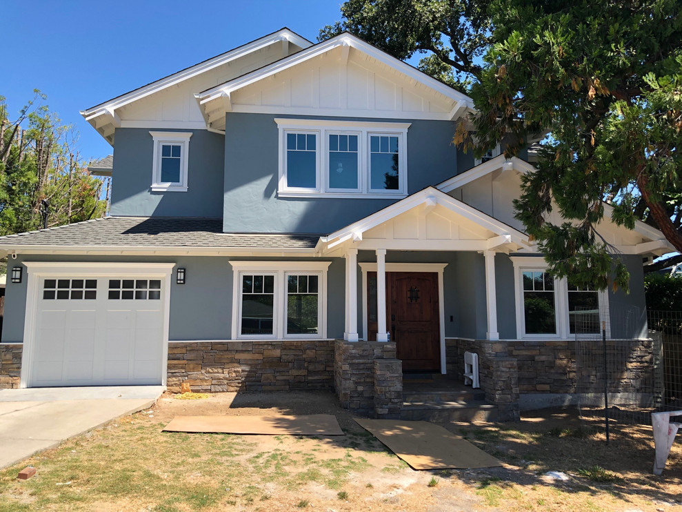 Example of a large arts and crafts blue two-story stucco house exterior design in San Francisco