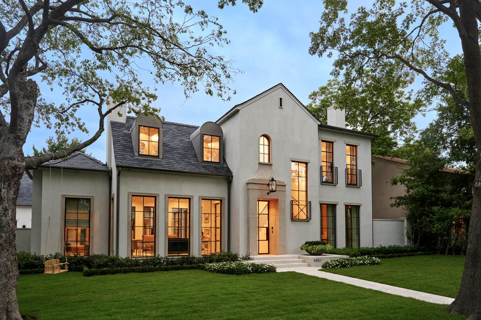 Example of a transitional beige two-story exterior home design in Dallas with a shingle roof