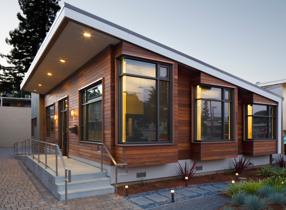 This is an example of a brown contemporary bungalow house exterior in San Francisco with wood cladding and a lean-to roof.