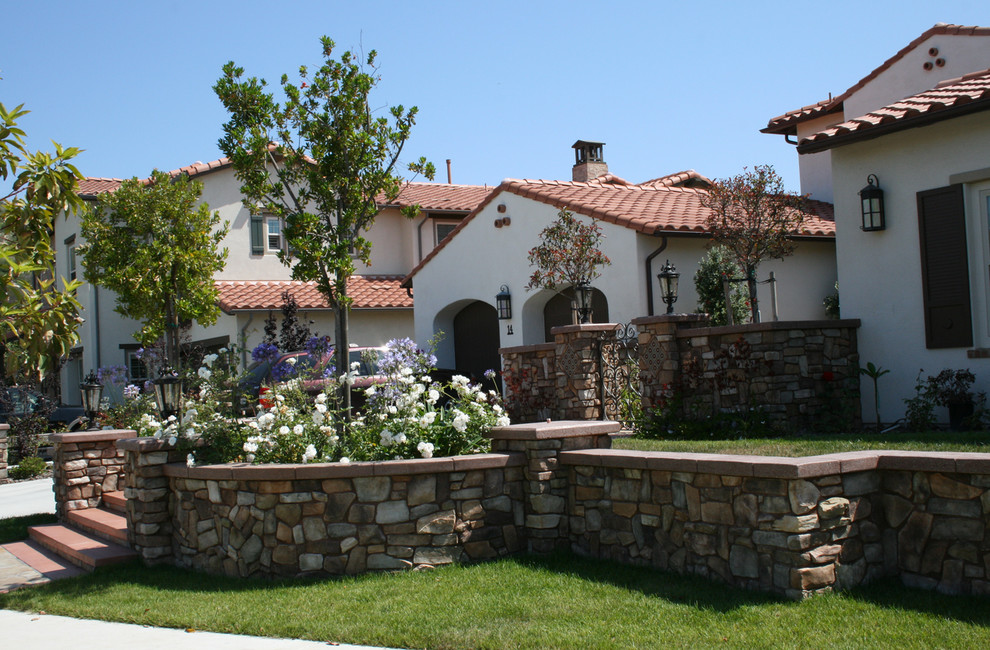 Photo of a large and white mediterranean two floor render house exterior in Los Angeles.