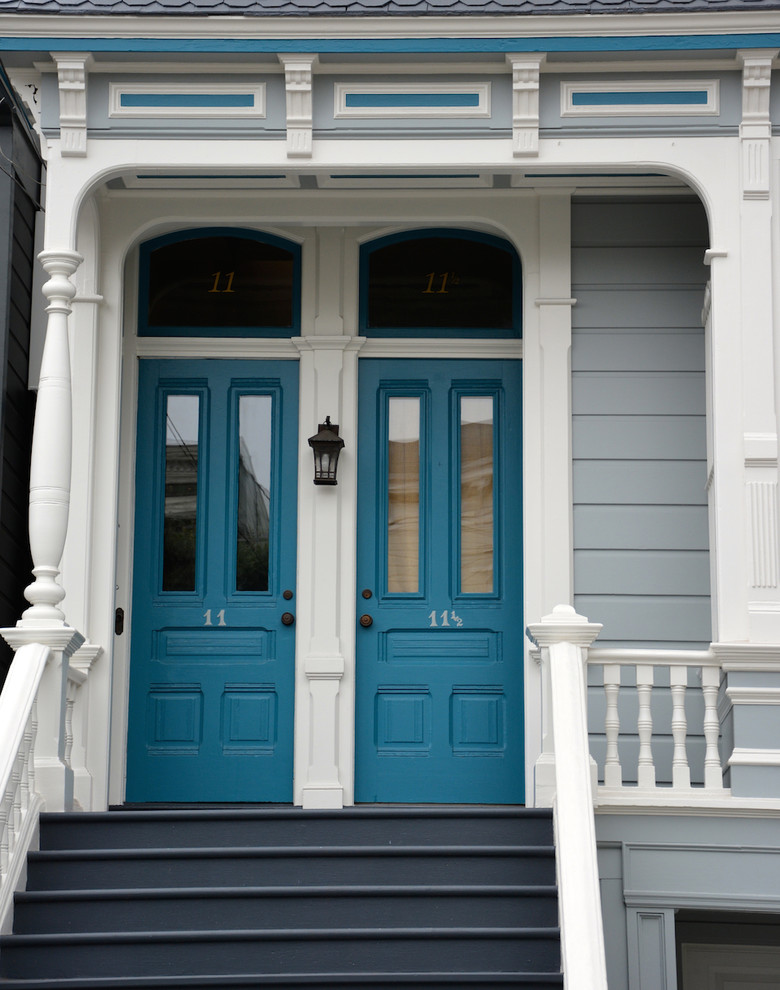 Example of a mid-sized ornate blue three-story wood flat roof design in San Francisco