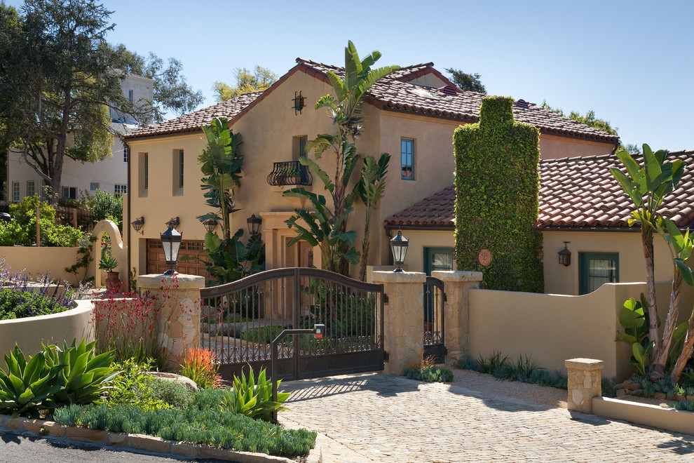 Photo of a large and beige mediterranean two floor render house exterior in Santa Barbara.