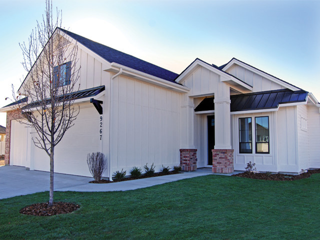 This is an example of a medium sized and white traditional bungalow house exterior in Boise with mixed cladding and a pitched roof.