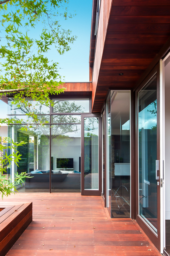 Ejemplo de fachada blanca minimalista de tamaño medio de dos plantas con revestimiento de madera y tejado plano