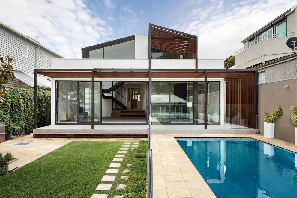 White contemporary two floor detached house in Melbourne with mixed cladding and a pitched roof.