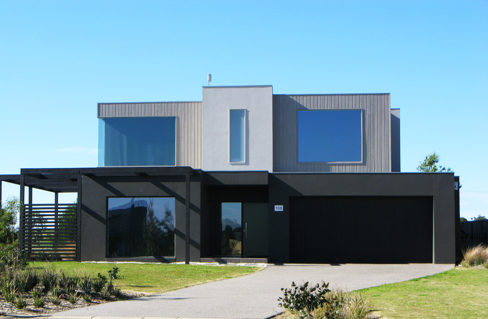 Example of a mid-sized trendy gray two-story brick exterior home design in Geelong with a metal roof