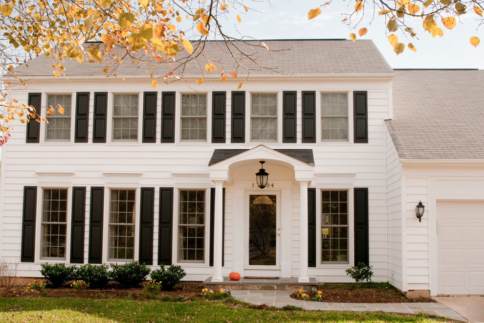 Inspiration for a mid-sized timeless white two-story vinyl exterior home remodel in DC Metro with a shingle roof
