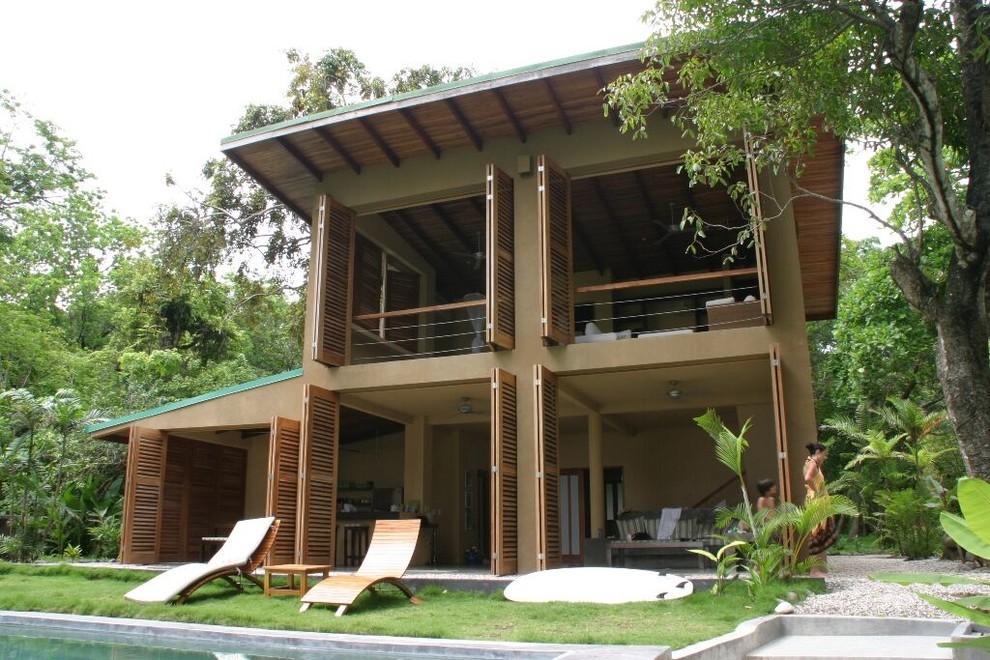 Foto della casa con tetto a falda unica marrone tropicale a due piani di medie dimensioni con rivestimento in legno