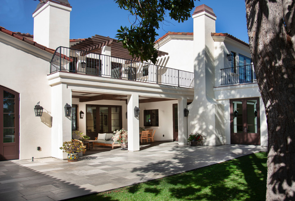 Huge mediterranean white two-story stucco house exterior idea in San Diego with a tile roof