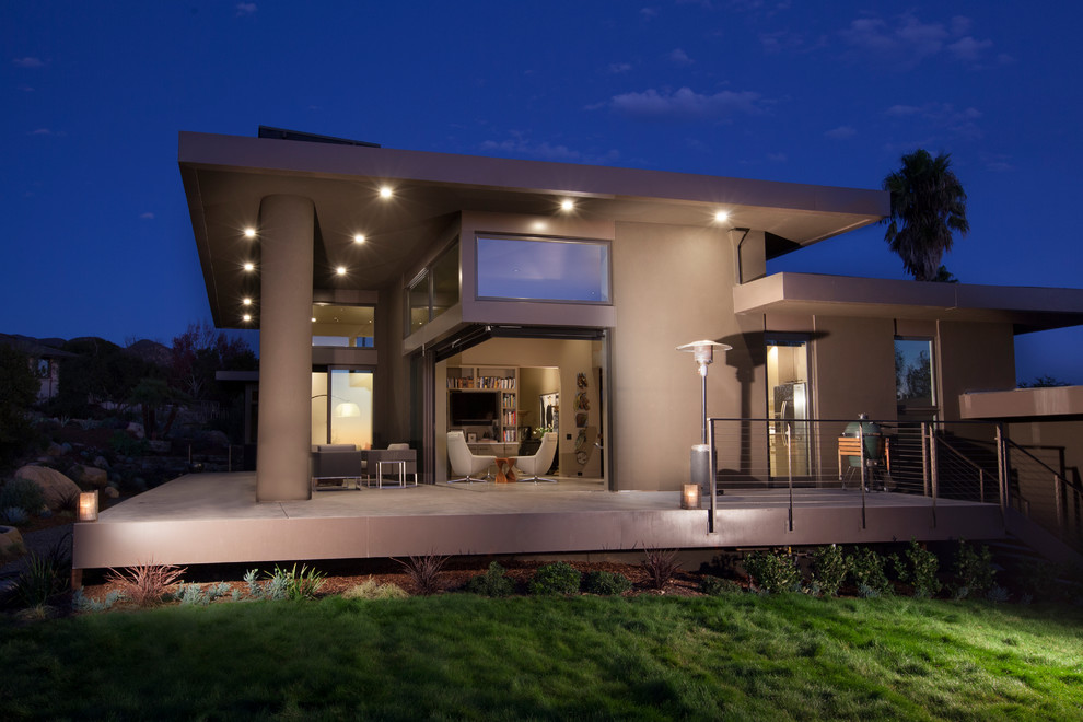 Large contemporary brown one-story stucco flat roof idea in Santa Barbara