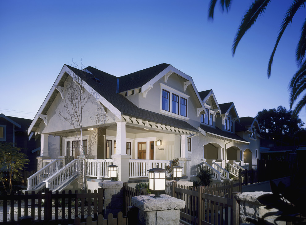 Example of a mid-sized arts and crafts gray two-story stucco exterior home design in Santa Barbara with a shingle roof
